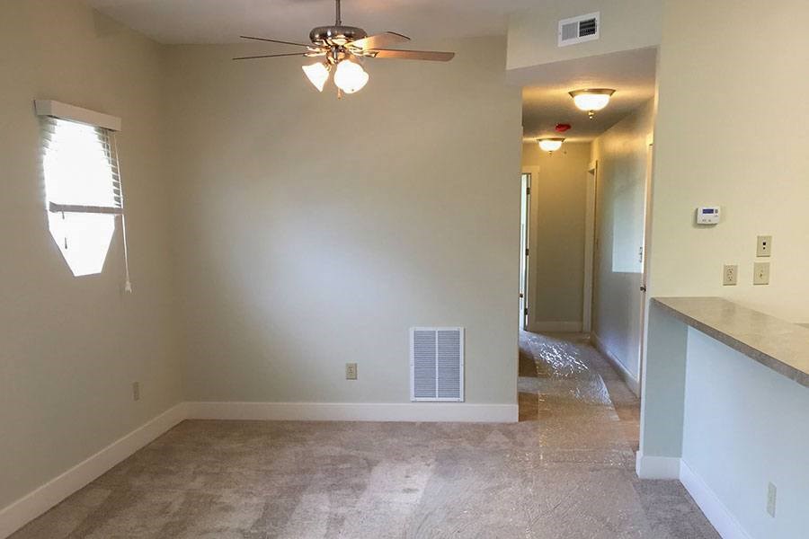 A room with a ceiling fan and a window.
