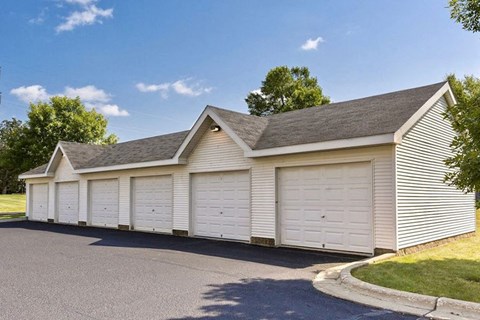 a white garage with white doors and a gray roof