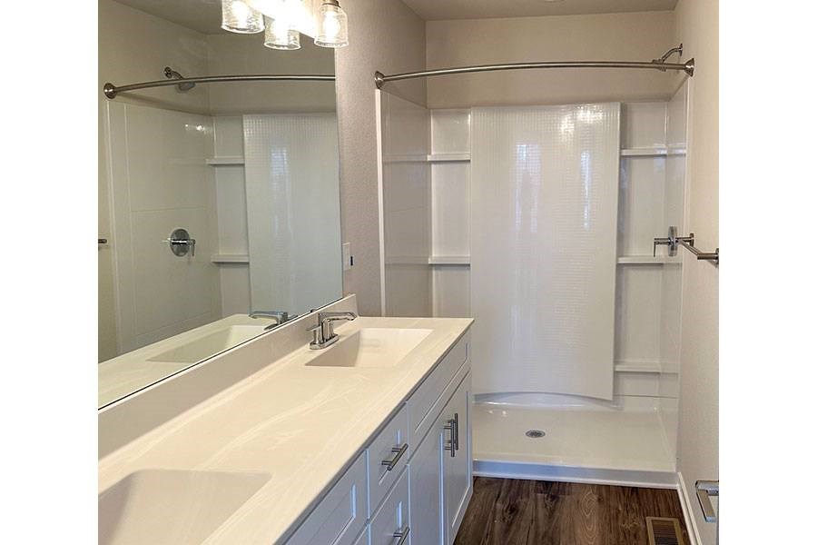 A white bathroom with a walk-in shower.