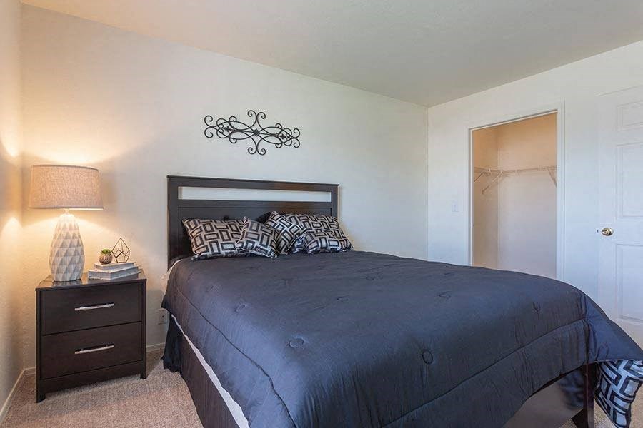 a bedroom with a large bed and a closet