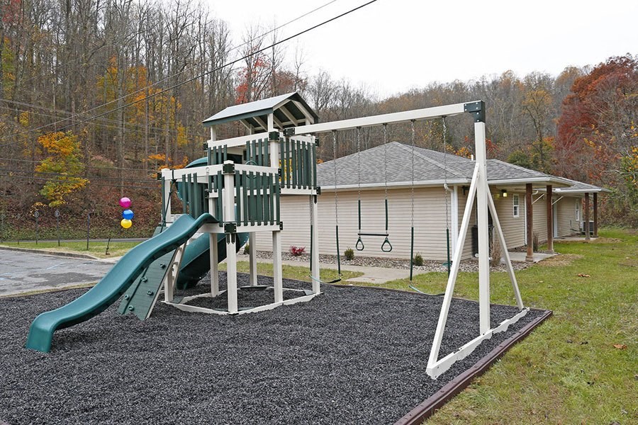a playground with a swing set and a slide