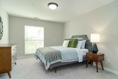 a bedroom with a bed and a night stand