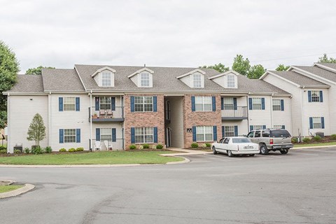 an apartment building with cars parked in front of it