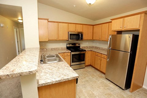 a kitchen with stainless steel appliances and granite counter tops