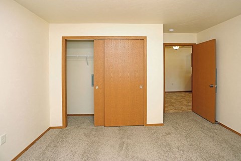 an empty room with a closet and a door