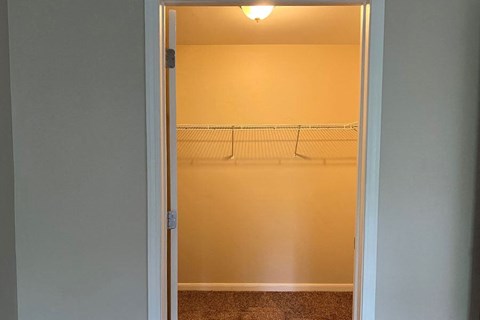 an empty room with a closet and a light