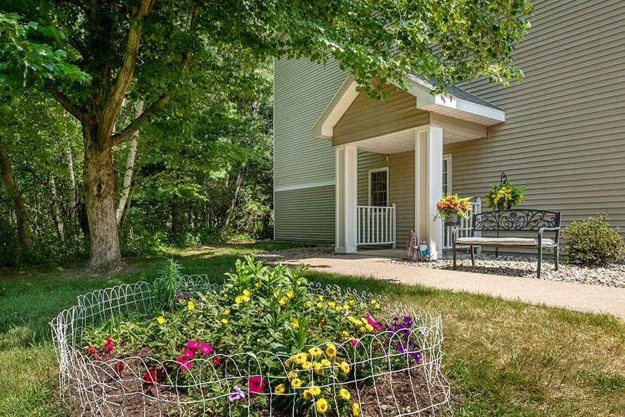 a house with a garden and a bench
