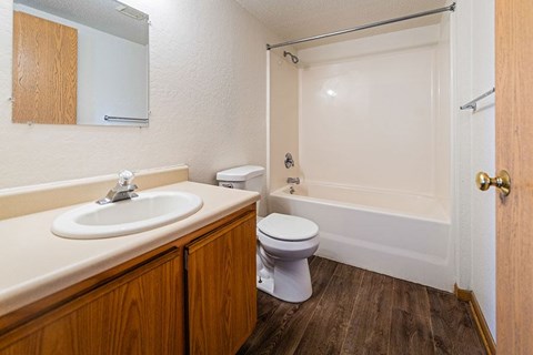 A white toilet sits next to a sink in a small bathroom.