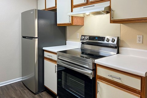 a kitchen with a stove and a refrigerator