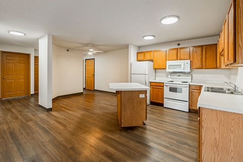 A kitchen with wooden cabinets and a white countertop.