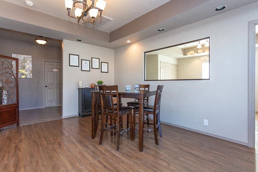 a dining room with a table and chairs