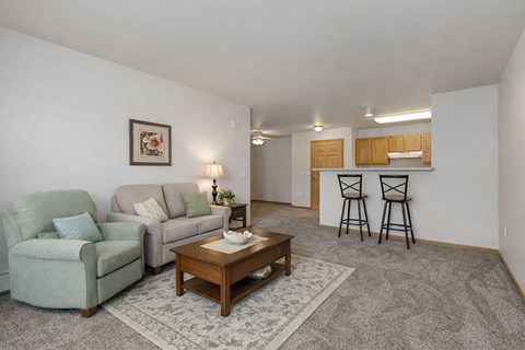 A living room with a couch, chair, and coffee table.