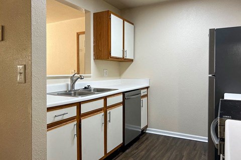 a kitchen with a sink and a refrigerator