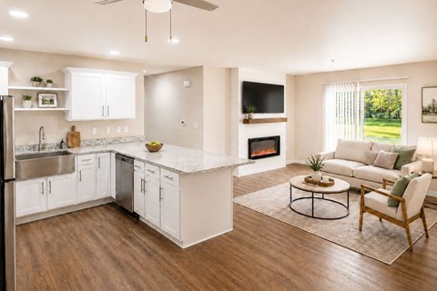 A modern kitchen with white cabinets and a wooden floor.