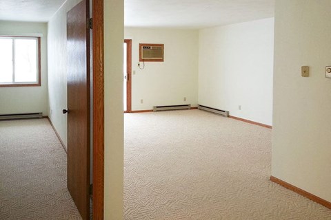 an empty room with a door and a window