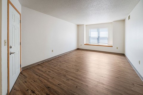 A room with wooden floors and a window.