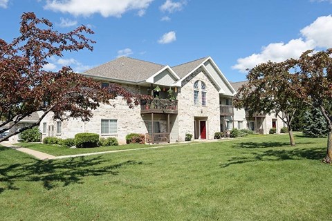 a white house with a yard and trees