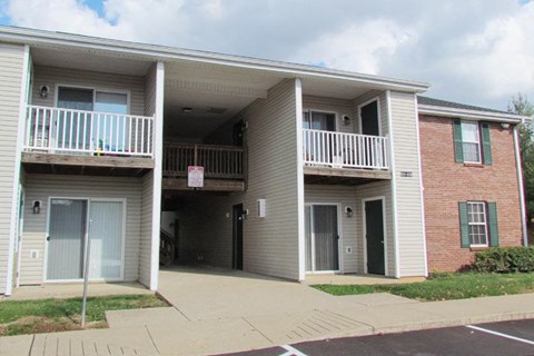 an apartment building with a balcony and a sidewalk
