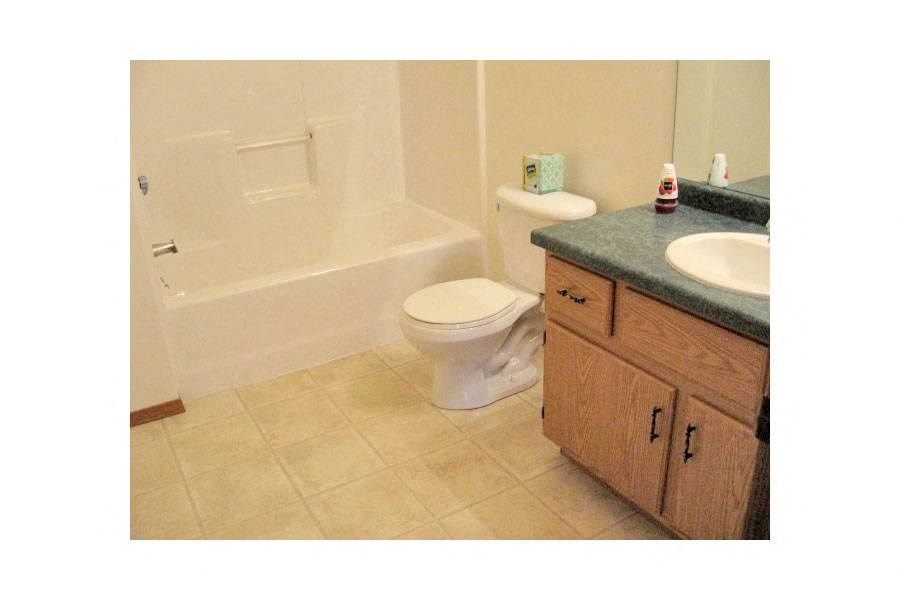 a bathroom with a toilet and a sink and a bath tub