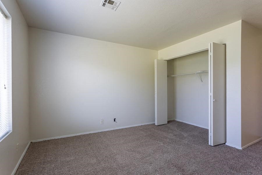 an empty living room with a closet