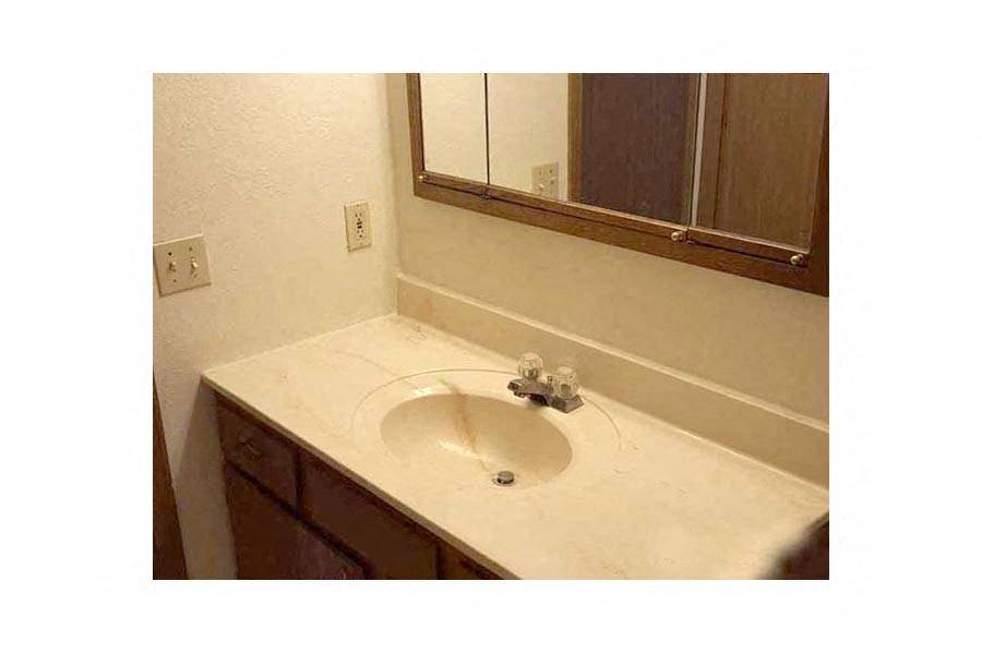 a bathroom with a sink and a mirror