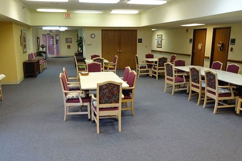 a multipurpose room with tables and chairs