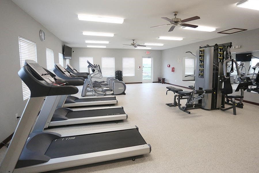 a gym with a lot of exercise equipment in it