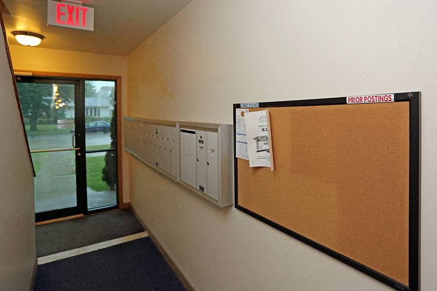 a room with a bulletin board and a glass door