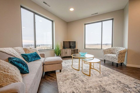 A living room with a couch, a chair, and a coffee table.