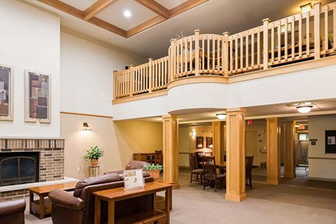 A living room with a fireplace and a balcony.