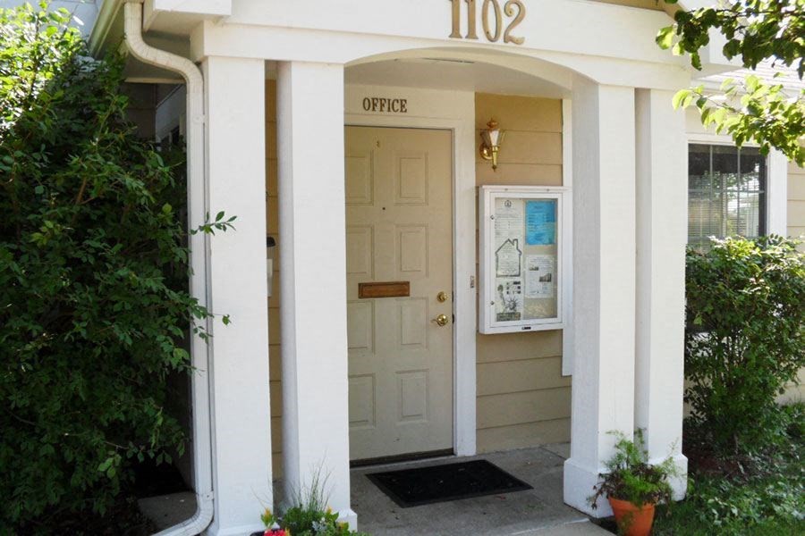 the front door of an apartment building with a white door
