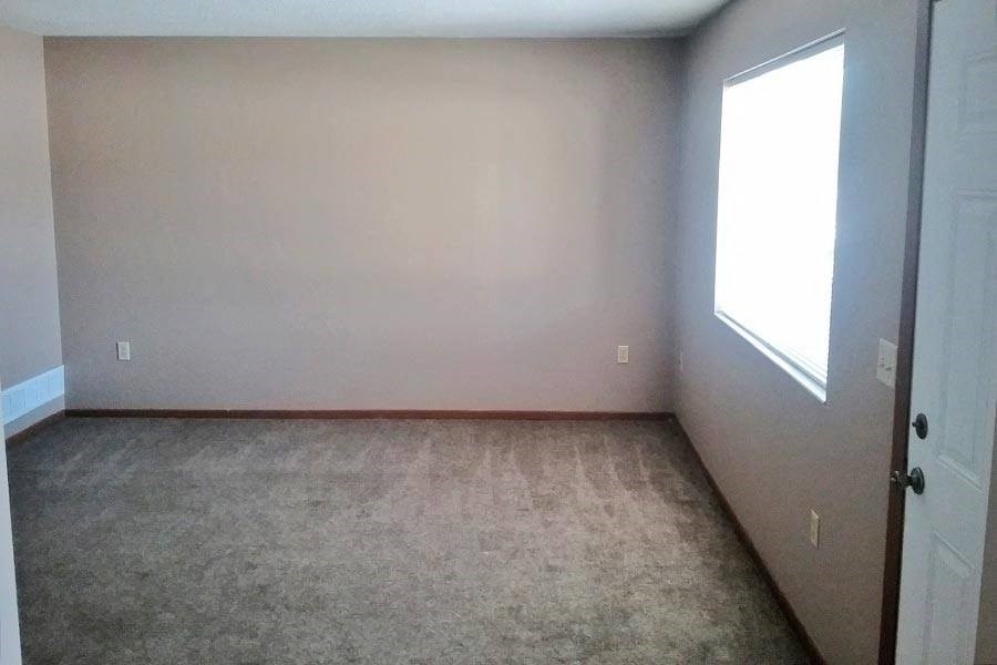 an empty room with a door and a window