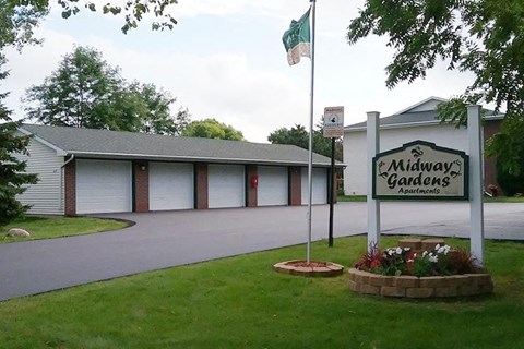 a building with a sign in front of a driveway