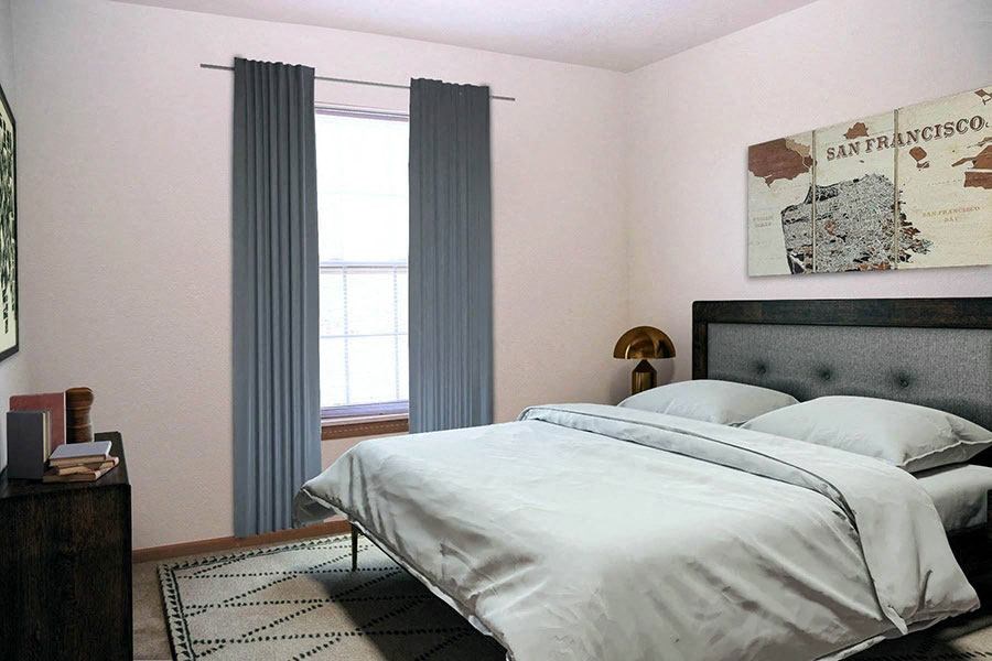 a bedroom with a bed and two windows