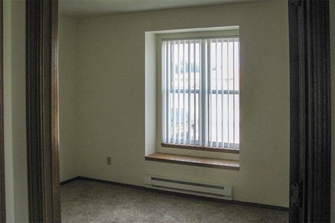 a window in an empty room with a window sill
