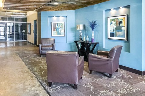 a lobby with purple chairs and a blue wall
