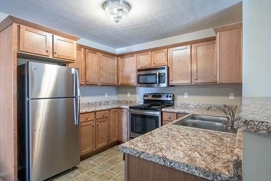 a kitchen with granite counter tops and stainless steel appliances