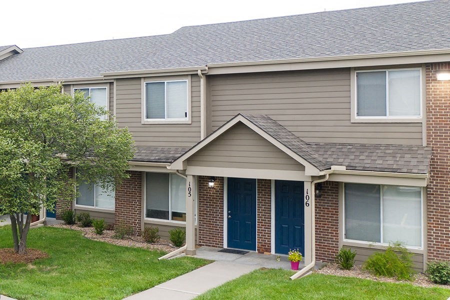 a brown house with a blue front door