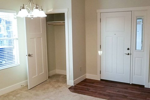 A white door is on the left and a white door with a black handle is on the right.