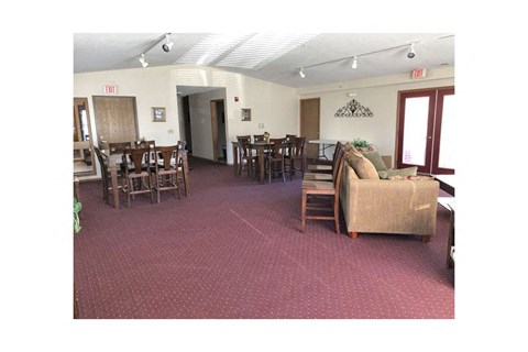 A room with a carpeted floor and a couch.