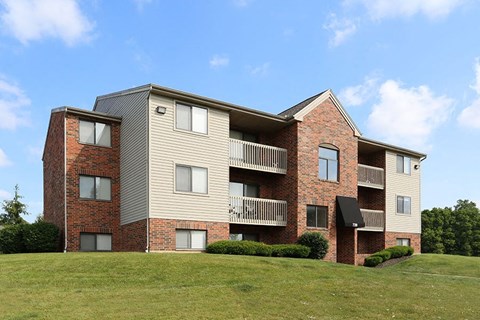 A large apartment building with a balcony on the second floor.