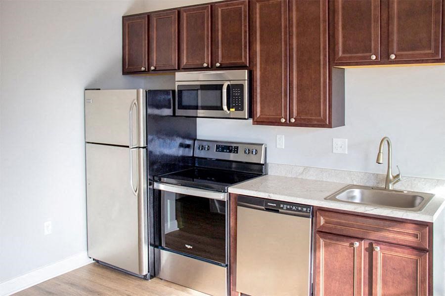 a kitchen with stainless steel appliances and wooden cabinets