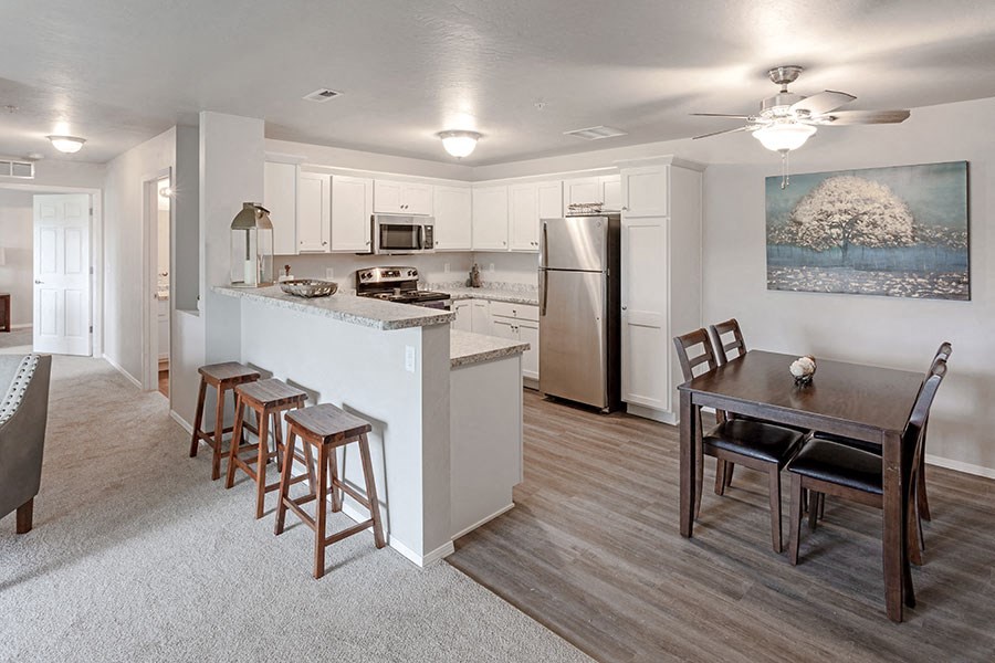 a kitchen and dining room with a table and chairs