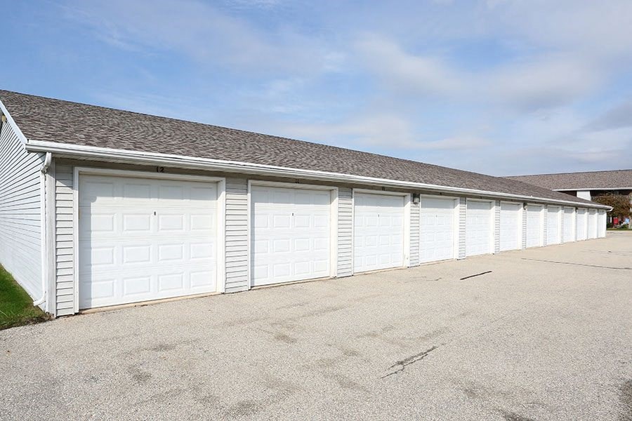 A row of white garage doors are closed.