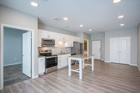 A kitchen with a table and chairs in the middle of the room.