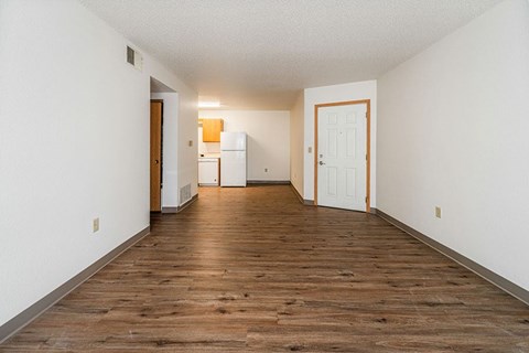 A room with a wooden floor and white walls.