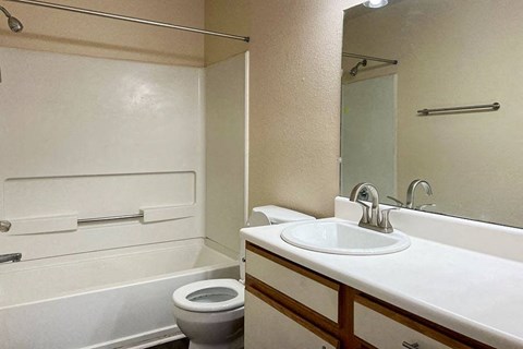 a white bathroom with a sink and a toilet