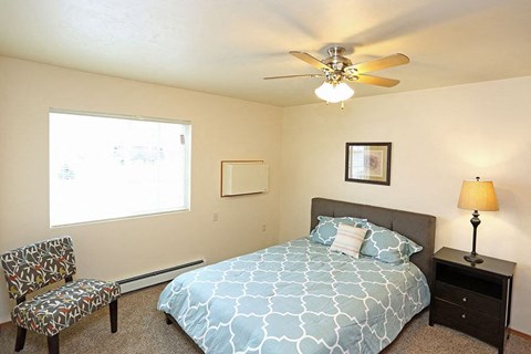 a bedroom with a bed and a ceiling fan