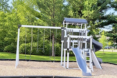 A playground with a slide and a swing set.