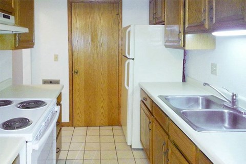 a kitchen with a stove and a sink and a refrigerator